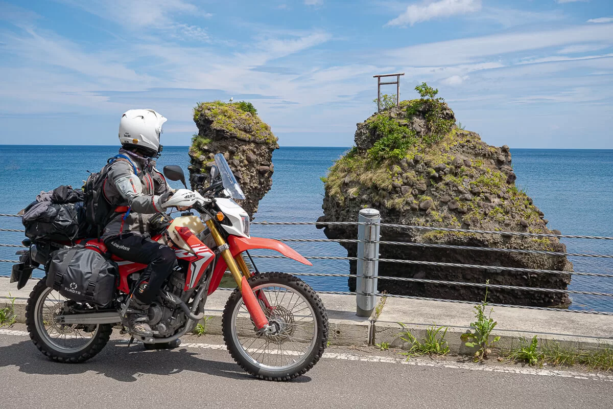 honda motorcycle in front of small torii gate